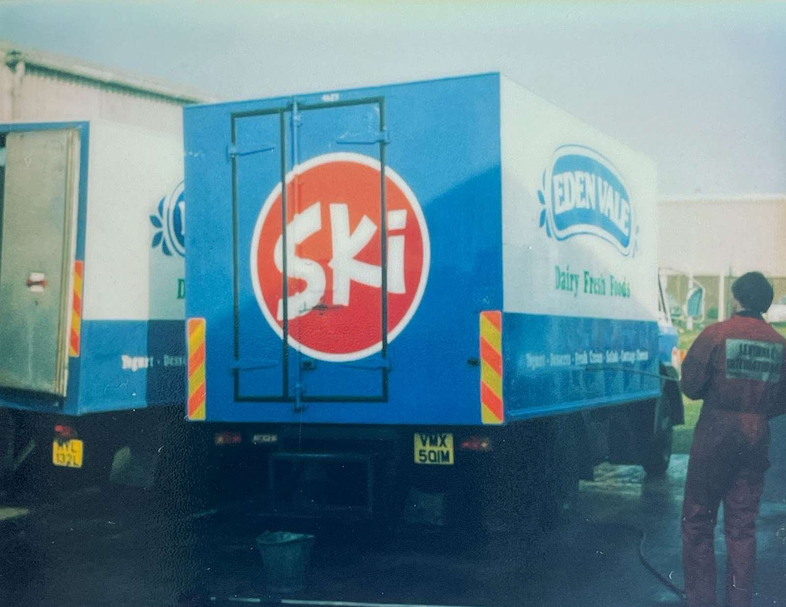 Workers washing Ski yogurt and Edenvale dairy trucks.